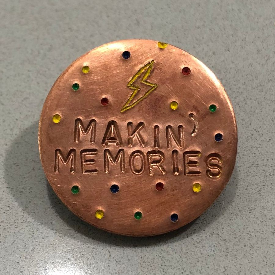 Copper marker stamped Makin' Memories with colored dots