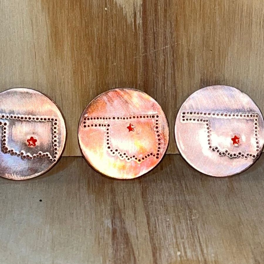 Copper markers with dot-punched Oklahoma outlines