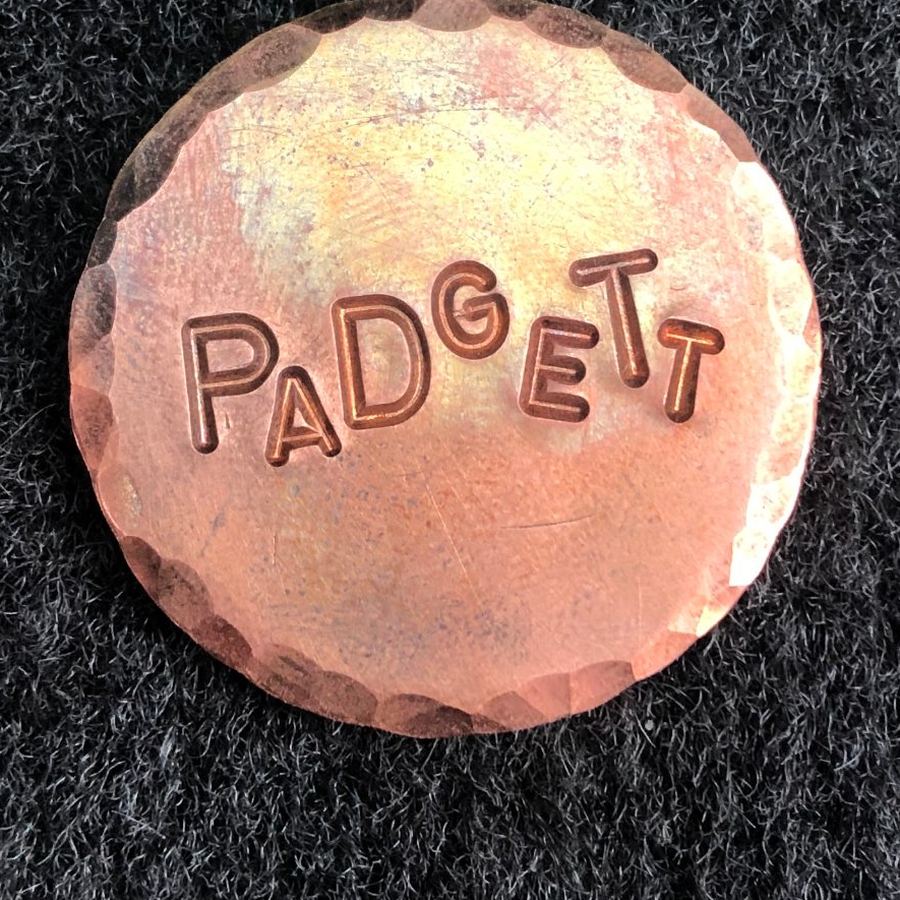 Copper marker stamped PADGETT in bouncy letters